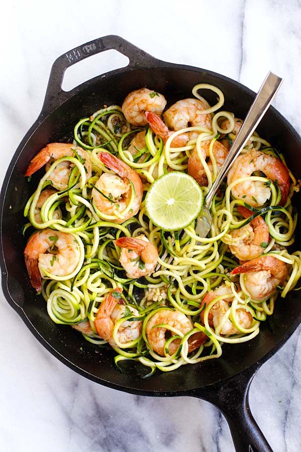 Sauteed brown butter cilantro lime shrimp zucchini noodles in skillet with a fork.