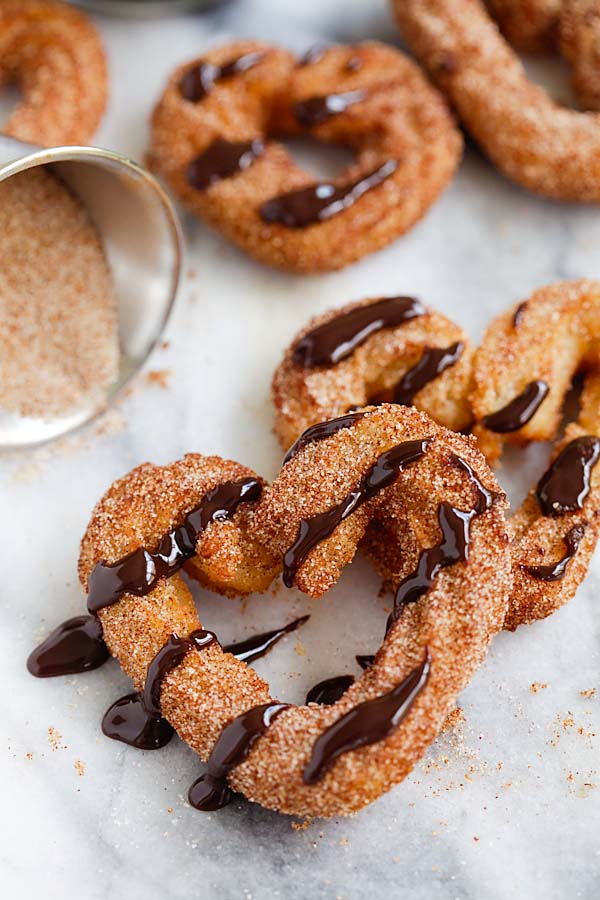 Easy and tasty baked churros dripped with chocolate sauce, ready to serve.
