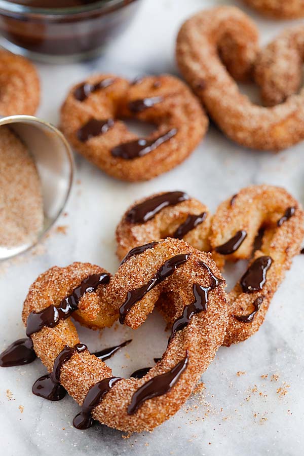 Crispy homemade churros puff pastry drizzled with chocolate sauce.