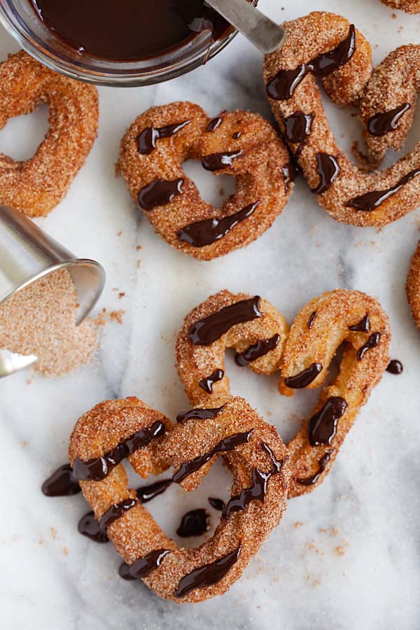 Easy heart shaped churros drizzled with chocolate sauce.