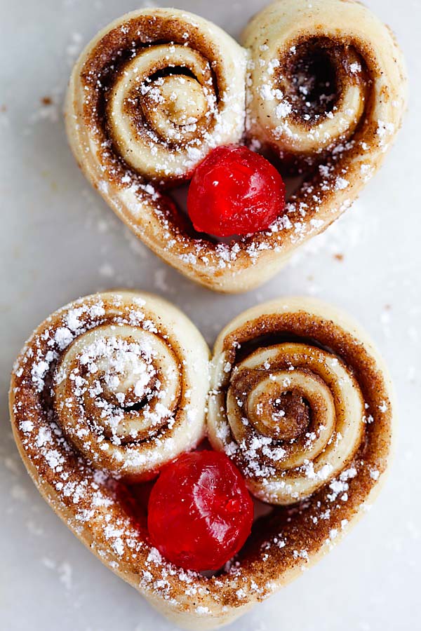 Easy baked heart shaped cinnamon rolls with cherries.