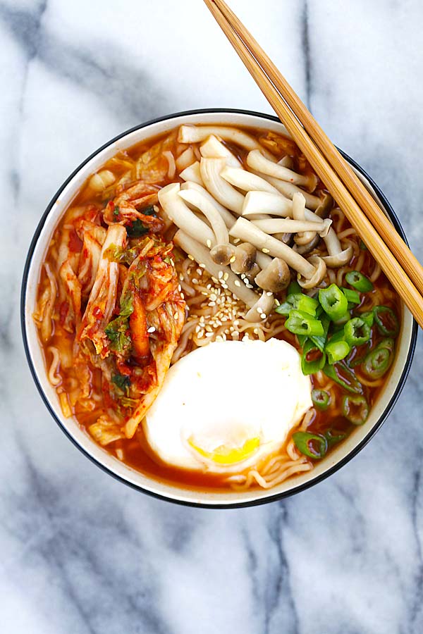 Easy spicy Korean ramen with kimchi, mushroom and poached egg in a bowl.