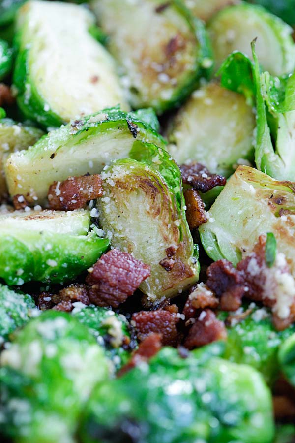 Easy and quick garlic Parmesan cheese and bacon Brussels sprouts roasted in a cast-iron skillet.