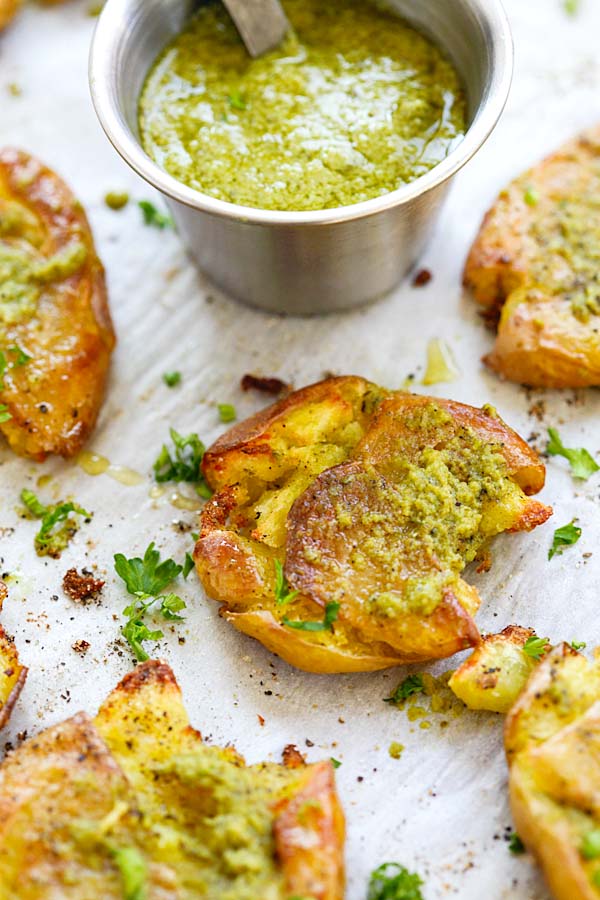 Easy and quick garlic pesto sauce topped on baked smashed potatoes.