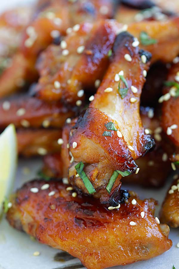 Closed up honey miso Japanese chicken wings garnished with sesame seeds.