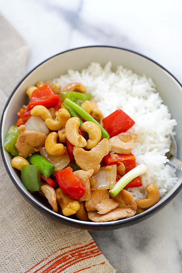 Thai stir-fry cashew nuts chicken served with a bowl of steamed rice.