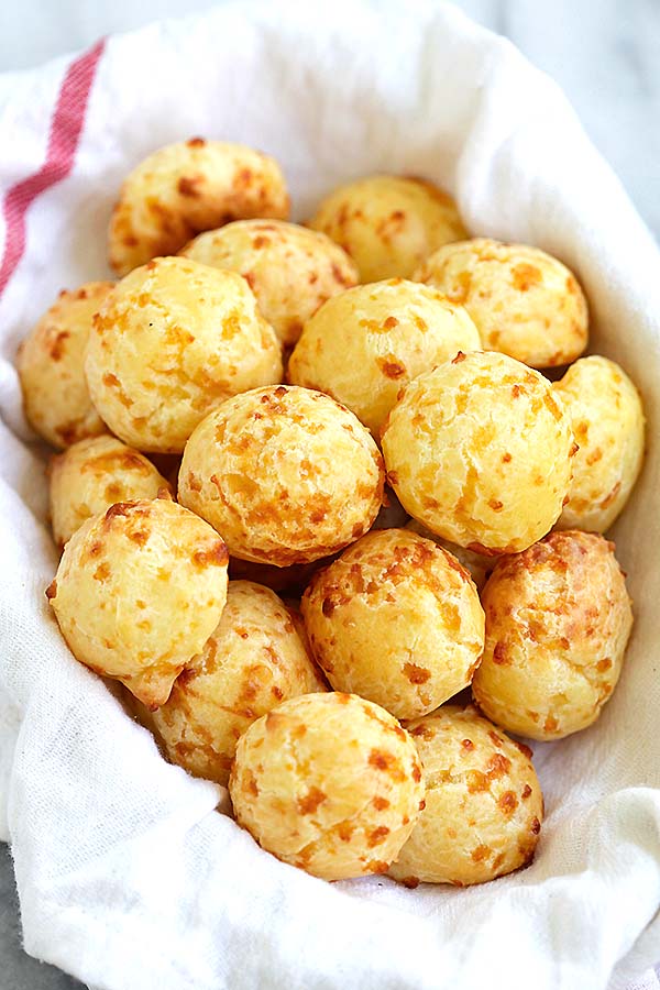 Easy and delicious homemade Brazilian cheese ball puff pastries in a basket.