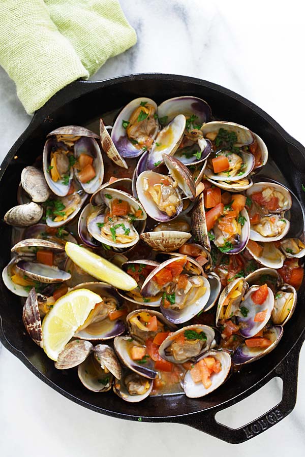 Easy and quick Italian-style skillet sauteed clams with garlic, tomatoes, white wine and parsley.