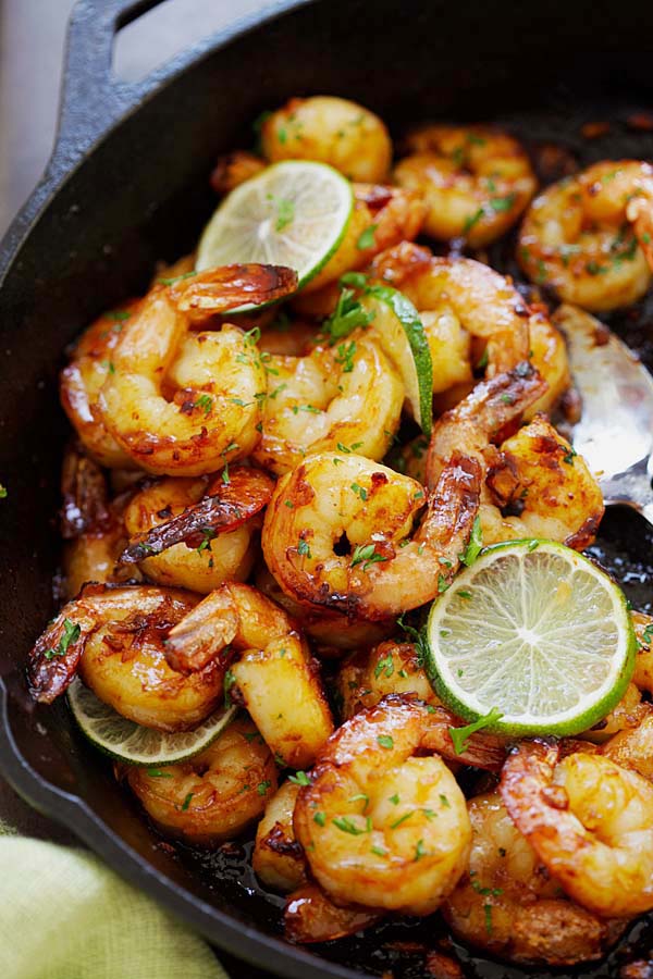 Easy and delicious sauteed garlic honey lime shrimp in a skillet.