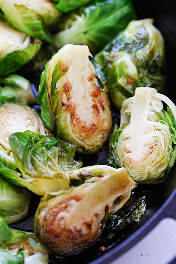 Easy and healthy sauteed honey balsamic Brussels sprouts in a skillet, ready to serve.