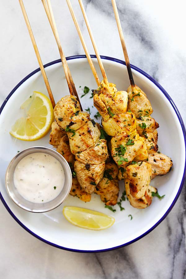 Chicken Souvlaki in skewers, with a side of ranch dressing.