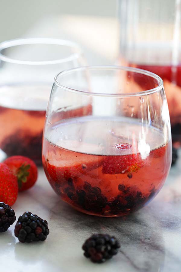 Easy and quick Rosé Sangria with wild berries served in cocktail glasses.