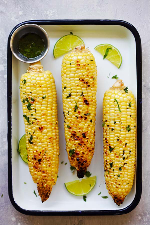 Top down view of buttery grilled corn marinade with honey, cilantro and lime juice.