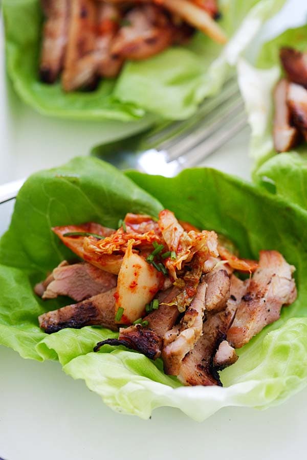 Korean Kimchi BBQ Chicken wraps in lettuce leaves, ready to serve.