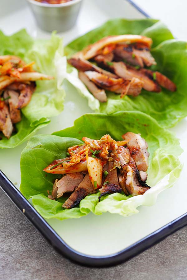 Delicious and easy Korean BBQ Chicken wraps in lettuce leaves with kimchi.