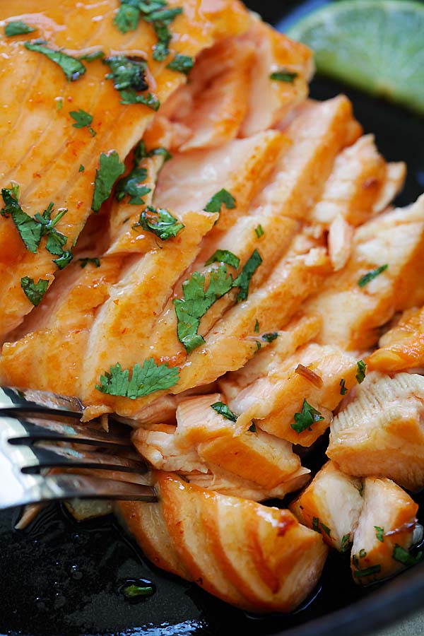 Easy and healthy homemade Sriracha Lime Salmon with a fork, ready to serve.