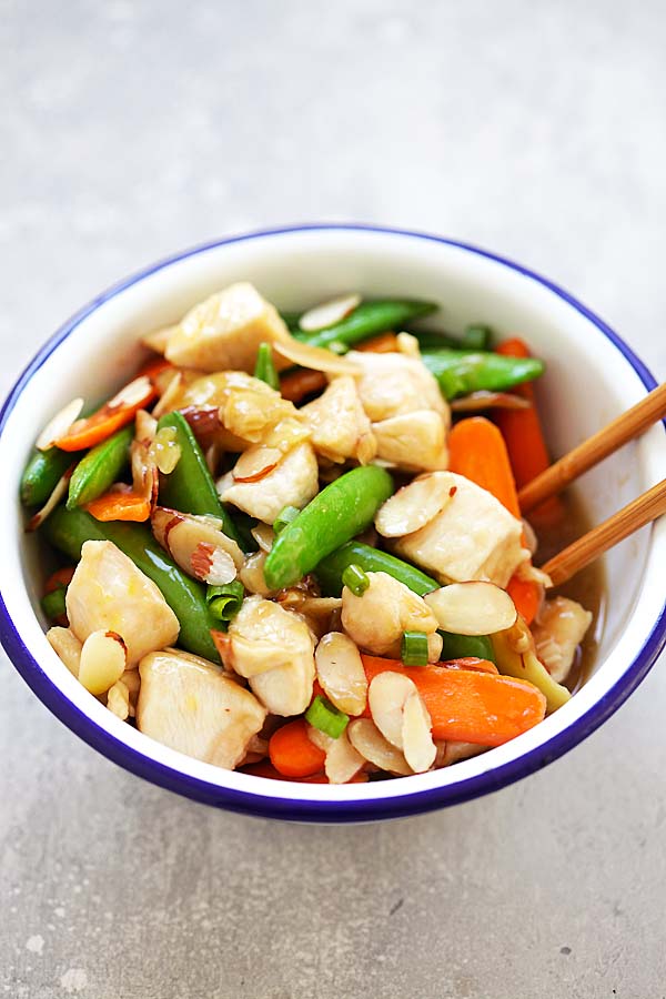 Easy and quick Asian Almond Chicken stir-fry with almonds, peas and carrots in Chinese brown sauce.