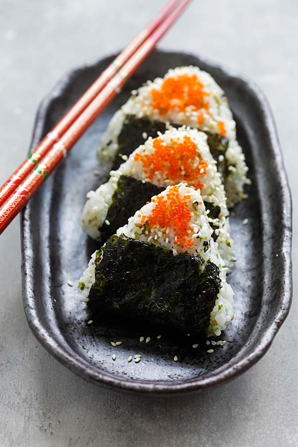 Easy and delicious Japanese rice balls shaped in triangles and wrapped with seaweeds, topped with Capelin fish roe and sesame seeds.