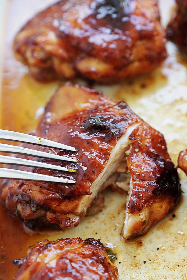 Easy baked honey barbecue chicken sliced and poked with a fork.