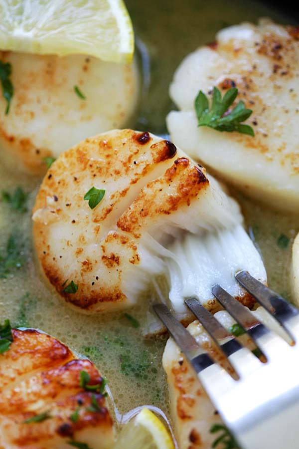 Easy delicious homemade pan-seared scallops with buttery lemon sauce, ready to serve.