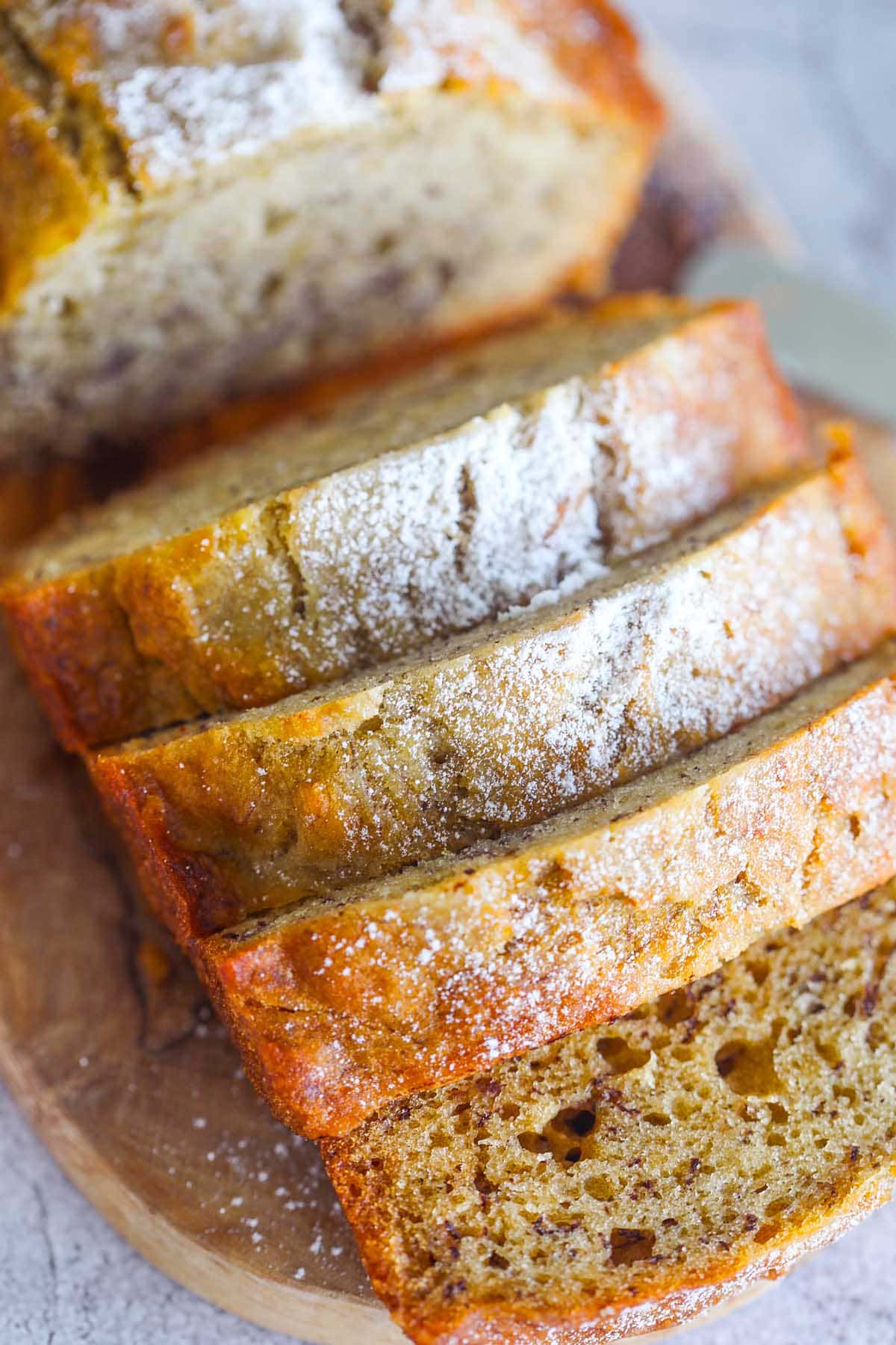 Moist banana bread on a serving platter.