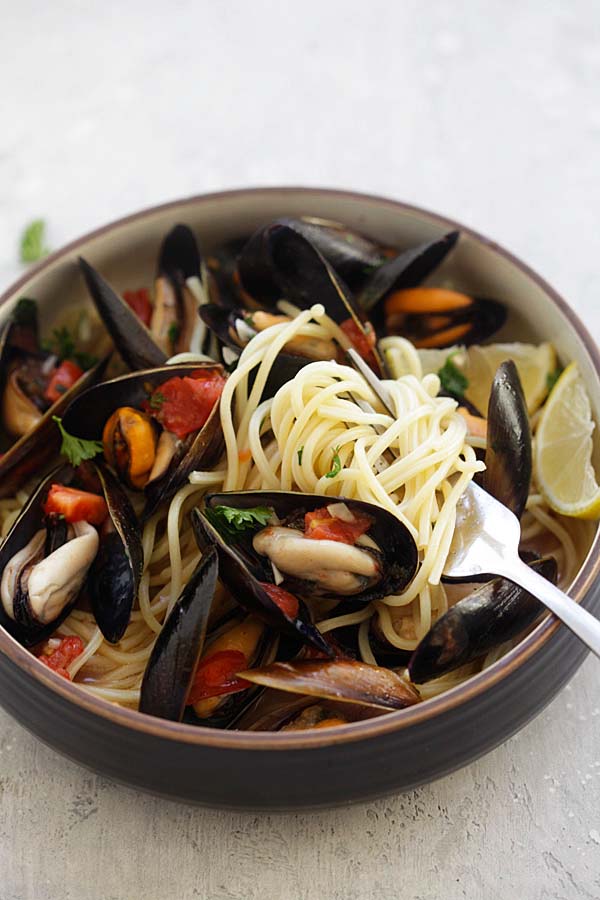 Steamed Mussels recipe with spaghetti pasta with a fork.