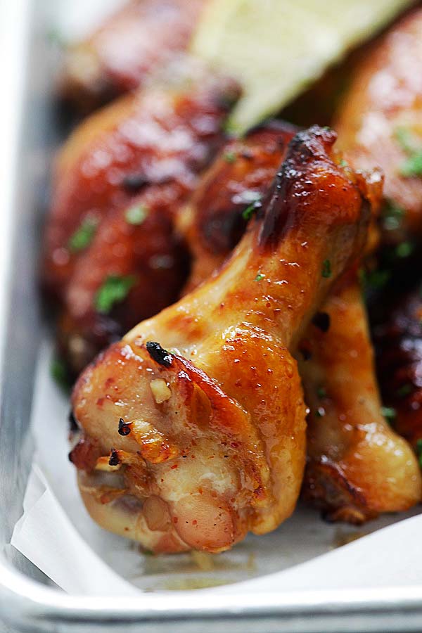 Close up of juicy brown chicken wings made with garlic and lemon marinade sauce, ready to serve.