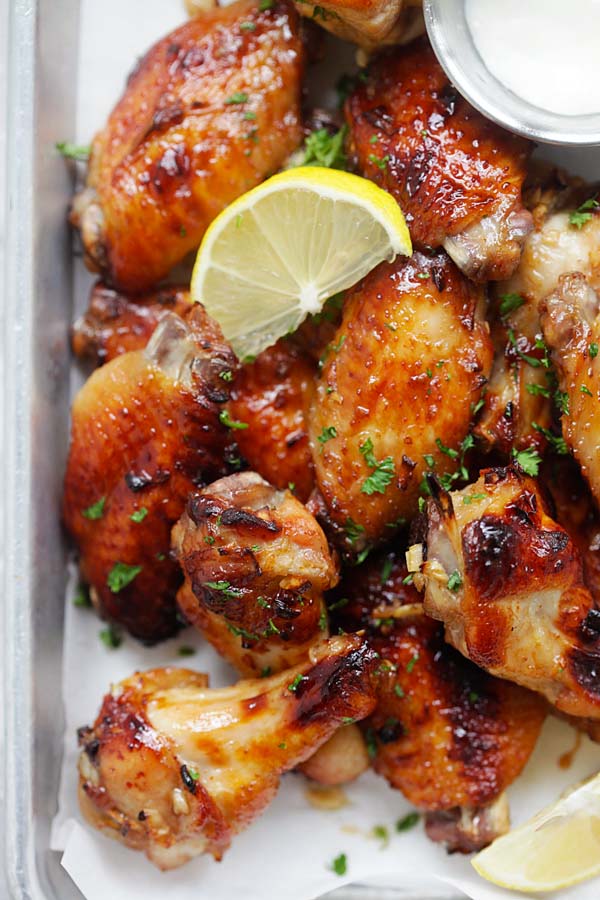 Juicy and delicious Baked Garlic Lemon Wings stacked in a baking tray.