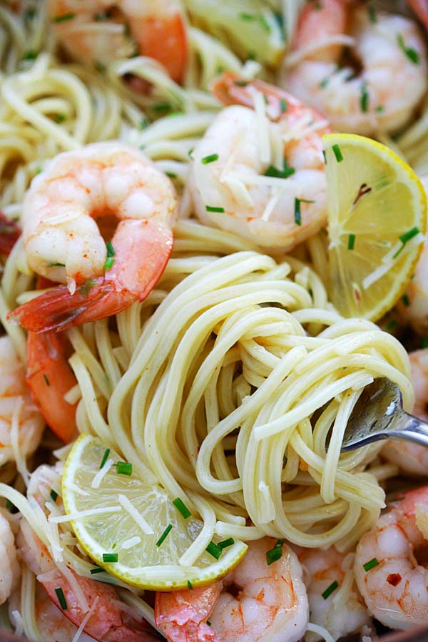 Garlic Chive Butter Shrimp Pasta close up with a fork, ready to serve.