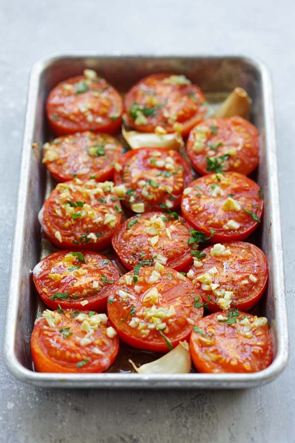 Easy and healthy roasted tomatoes topped with chopped garlic and chopped parsley.