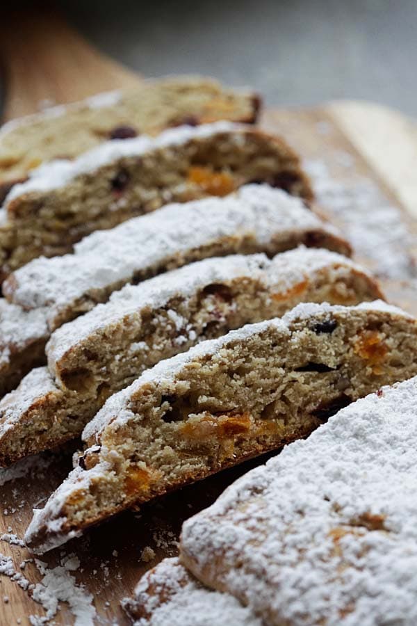 Easy Pecan and dried fruits Holiday Bread sliced on a wooden chopping board.