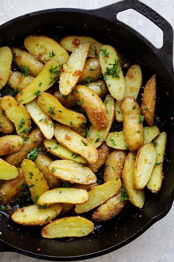 Crispy roasted fingerling potatoes in a skillet.