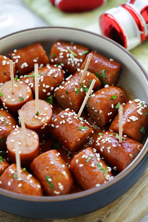 Easy and delicious Honey Sriracha Sausage Bites coated with honey sriracha glaze and sesame seeds.