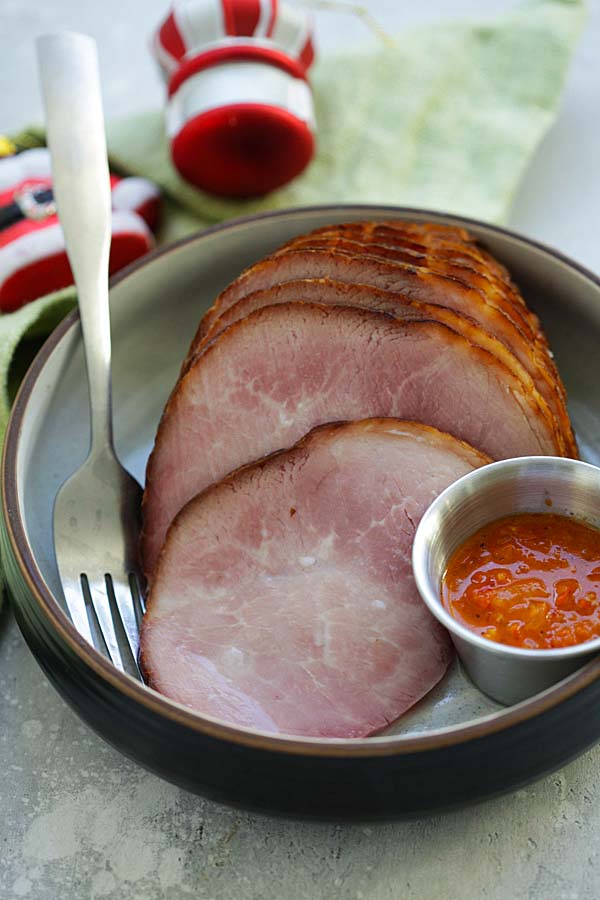 Slices of Holiday Ham with a side of piri piri sauce.