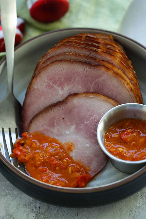 Hot and delicious Holiday Ham with some spices of piri piri sauce in a plate.