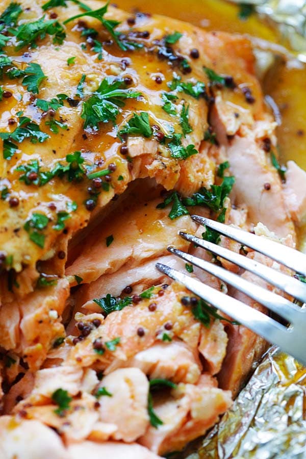 Close up healthy Foil baked salmon with honey, dijon mustard and Asian chili-garlic sauce.
