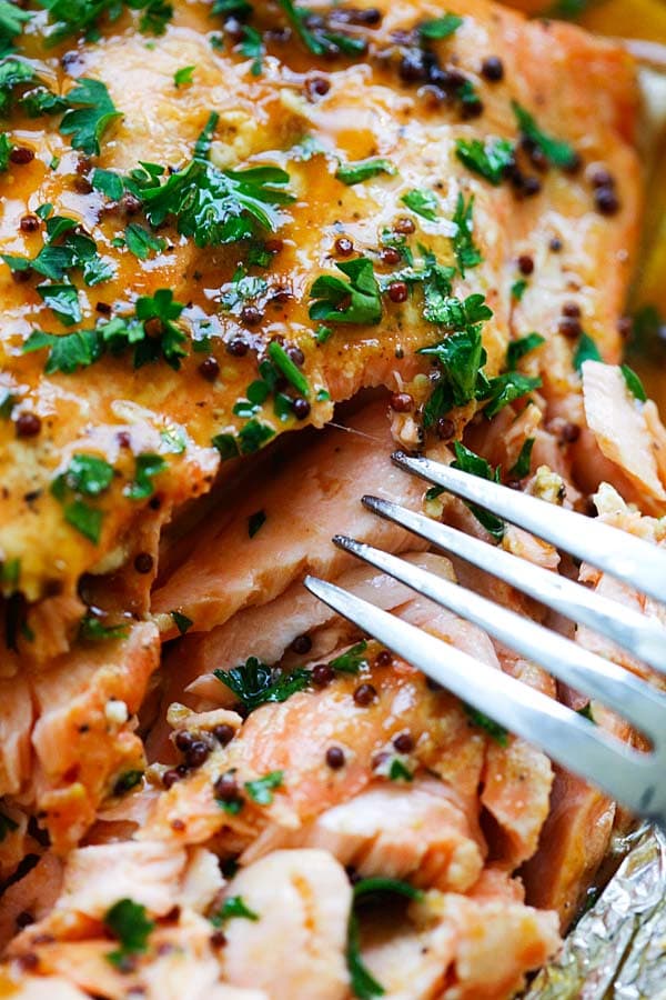 Homemade flaky spicy honey salmon with a fork.
