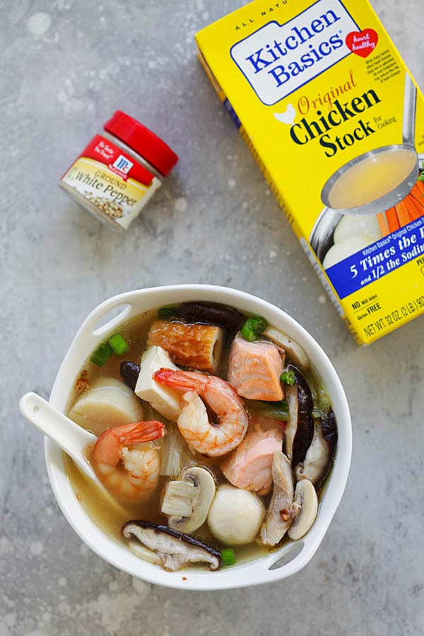 Chinese steamboat soup with a variety of fresh ingredients in a simmering pot of soup stock.