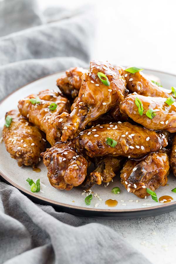 Teriyaki Chicken Wings with sticky sweet and savory teriyaki sauce on a plate.