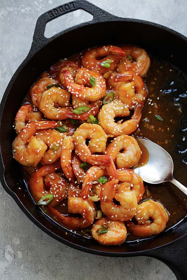 Sauteed shrimps with sweet and sour sauce in a skillet.