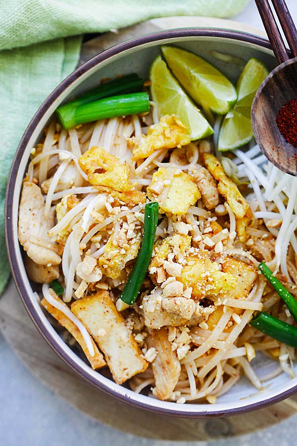 Chicken Pad Thai garnished with crushed roasted peanuts in a serving dish ready to serve.