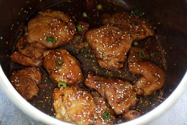 Chicken thighs pressured cooked inside an Instant Pot with honey sesame sauce. 