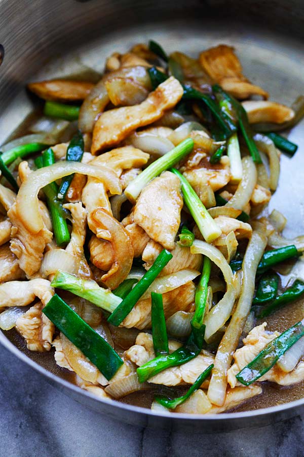 Easy homemade Chinese stir fry chicken with onion and scallions in brown sauce.