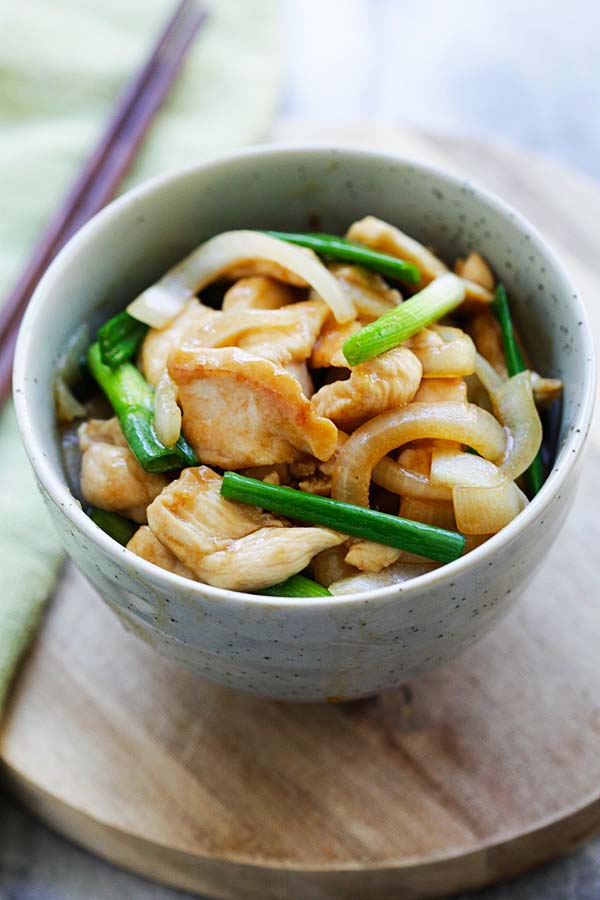 Onion scallion chicken stir fry served in a bowl.