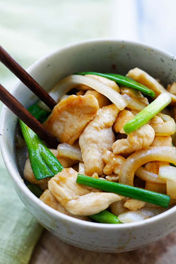 Chinese stir fry chicken with scallions and onion.