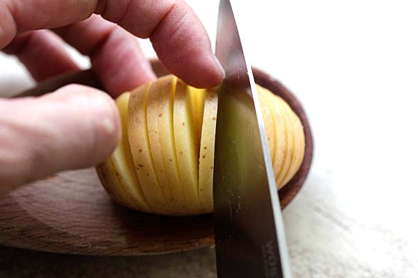 Slicing hasselback potato with a sharp knife