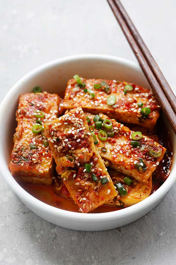 Spicy Korean Tofu in a white bowl, with a pair of chopsticks.