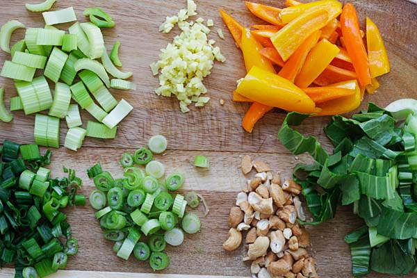 Fresh ingredients from Blue Apron on a wooden chopping board.