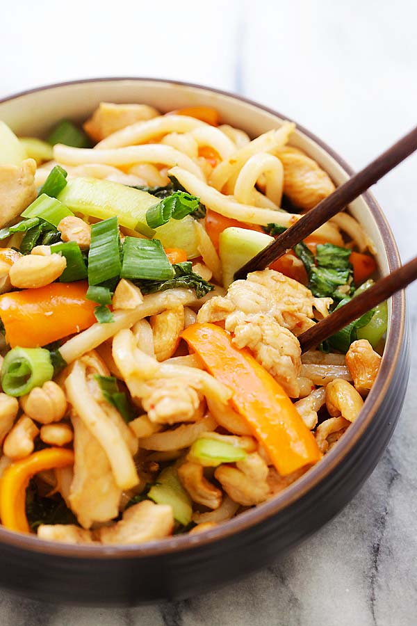 Blue Apron Stir-Fry Chicken with Udon garnished with scallions and crunchy cashews ready to serve.