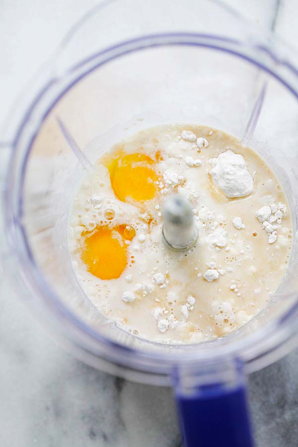 Dutch baby recipe batter ingredients: flour, eggs, milk, salt and butter in a blender.